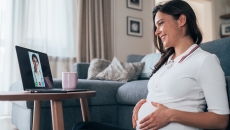 Pregnant women consulting with a healthcare professional via laptop computer