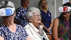 Aged care residents wearing VR headsets