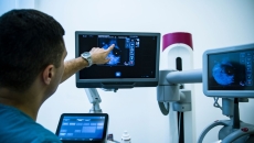 A doctor examining a mammogram