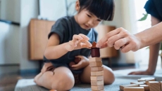 Person playing with blocks while sitting on the floor