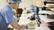 A surgeon checking on a patient's records