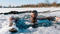 Person taking an ice bath while wearing a watch