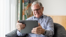 Senior patient looking at a tablet