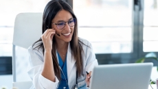 Healthcare professional interacting with a person via a PC