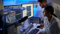 Healthcare professionals reviewing data on a computer