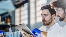 Two healthcare professionals looking at a tablet