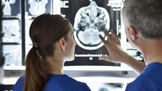 Healthcare professionals looking at MRI of the brain