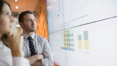 Businesspeople look at financial charts