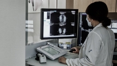 A radiologist assessing a mammogram using the Lunit INSIGHT MMG