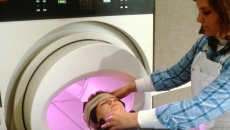 Technician prepares a patient for MRI