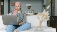 A cancer survivor using a laptop computer