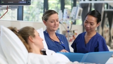 Virtus Health nurses assisting a patient in bed