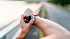A close up of a person checking a smartwatch.