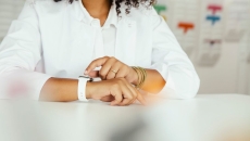 A woman using a smartwatch