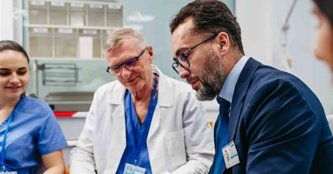 Advisor sitting with healthcare professionals