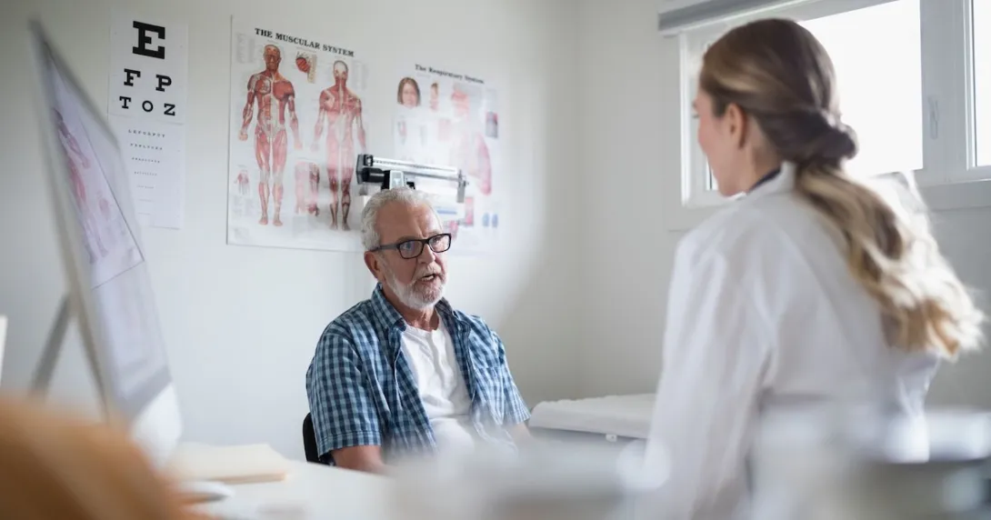 Healthcare provider sitting with a patient in the clinical setting