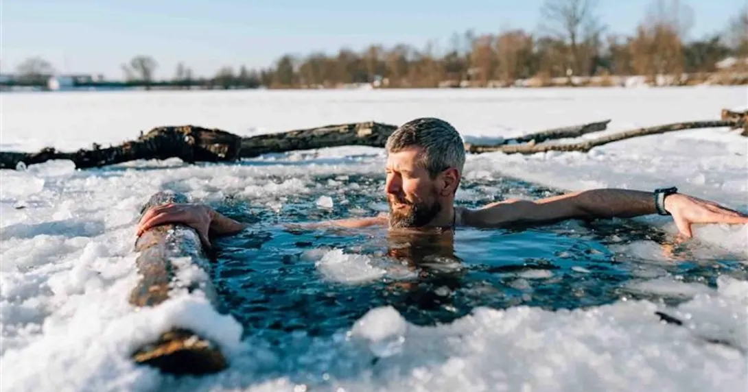 Person taking an ice bath while wearing a watch