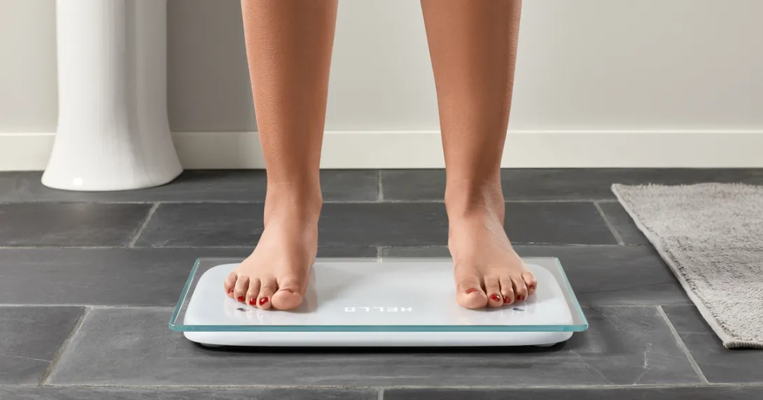 A person standing on the Cardiac Scale.