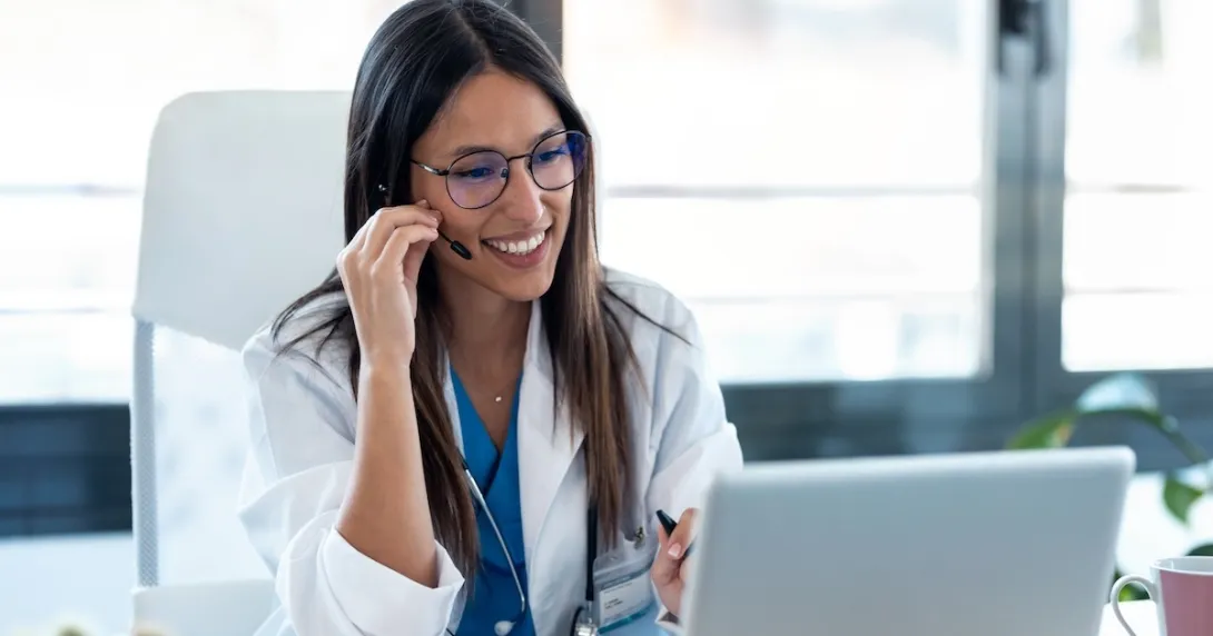 Healthcare professional interacting with a person via a PC