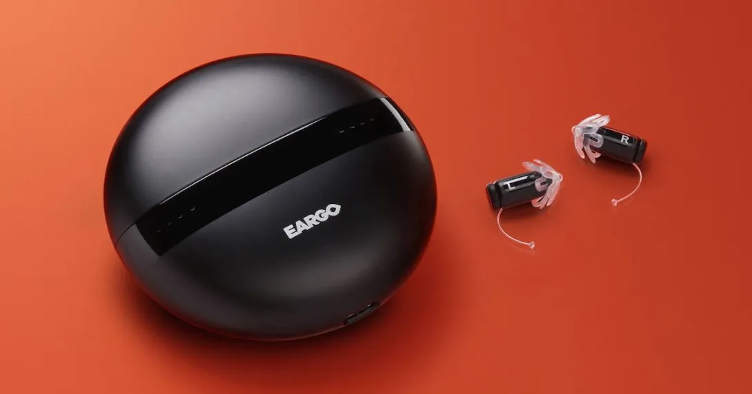 Eargo 5 with charging case on an orange backdrop