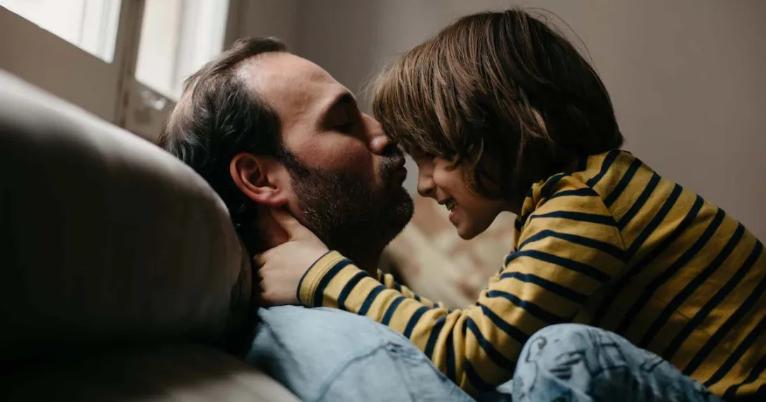 Father and son on a couch playing