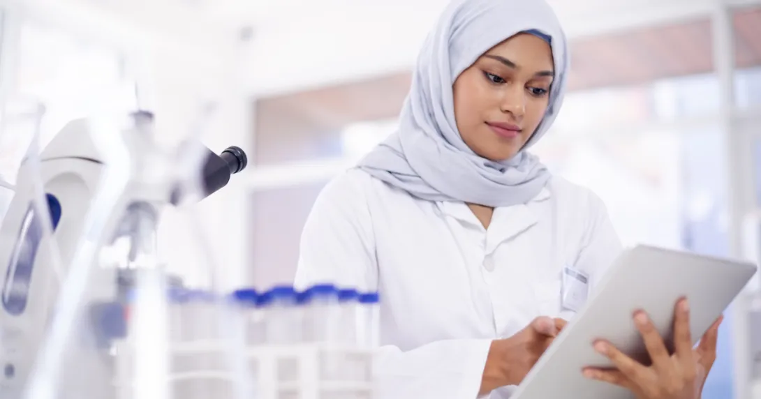 Scientist in a lab surrounded by microscopes