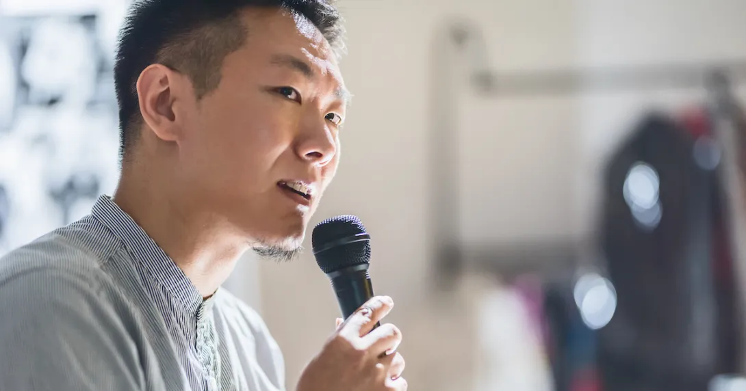 Person speaking in a microphone