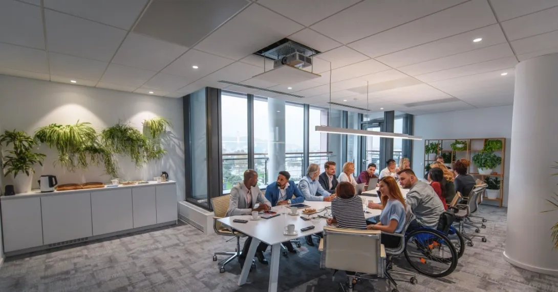 people sitting around glass table talking about business.