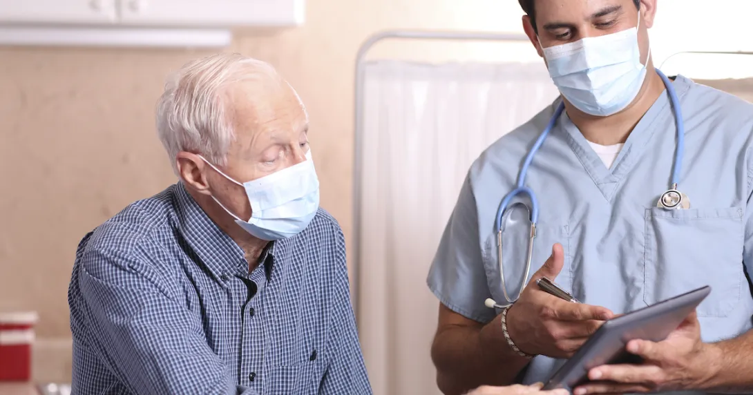 Healthcare provider and senior citizen on a tablet