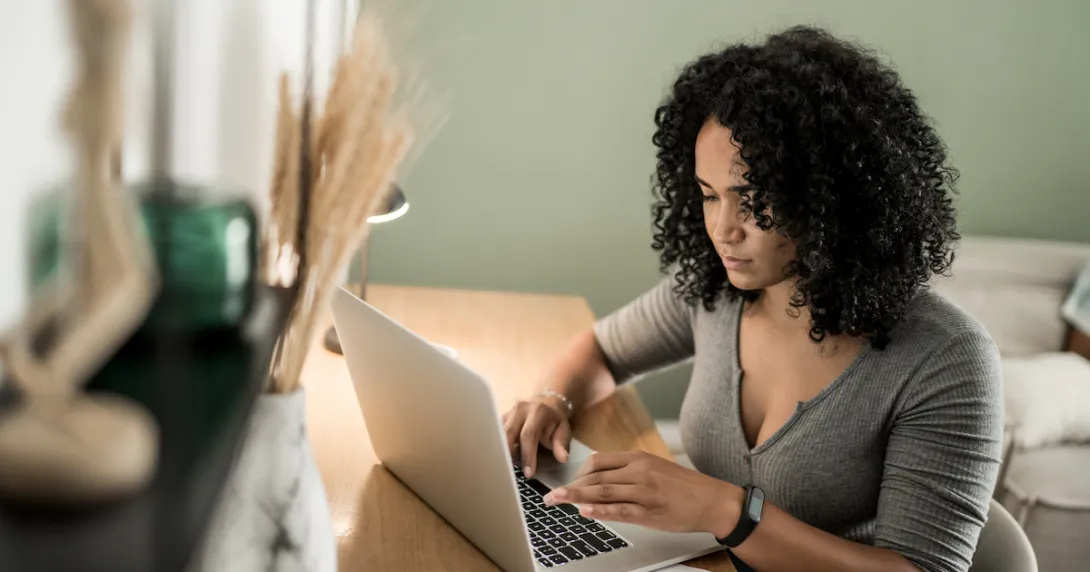 Person sitting at a desk looking at a computer