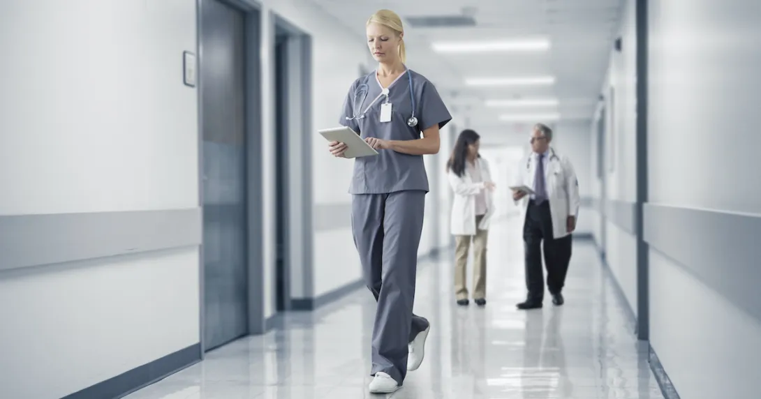 A nurse checking a patient's chart on a digital tablet