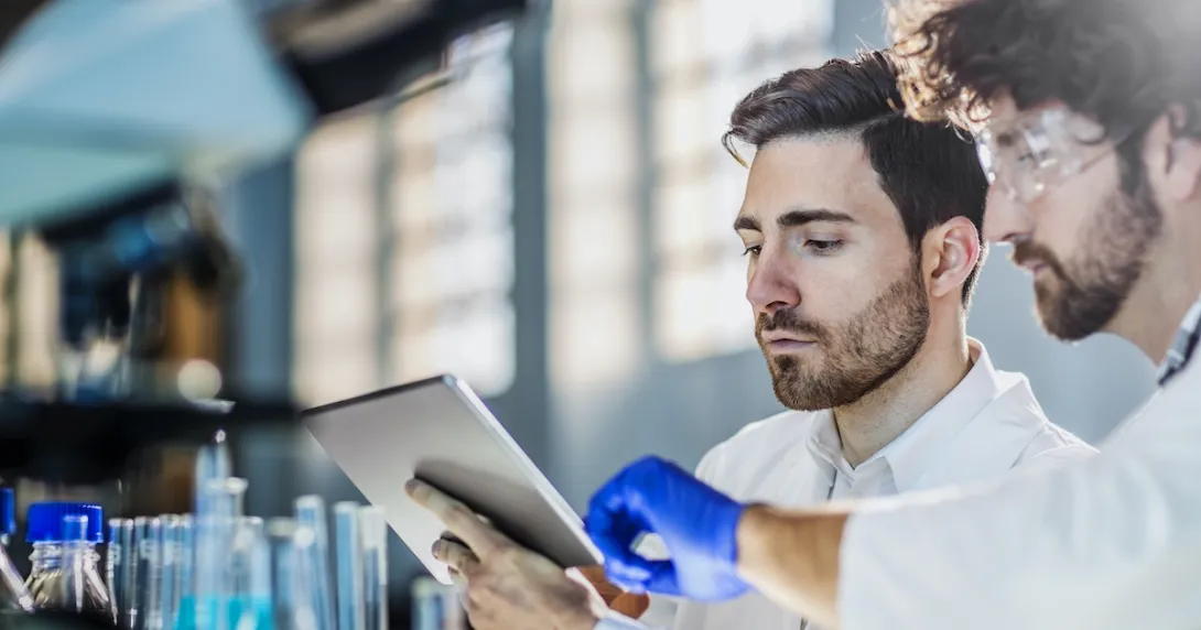 Lab researchers using a digital tablet in their research