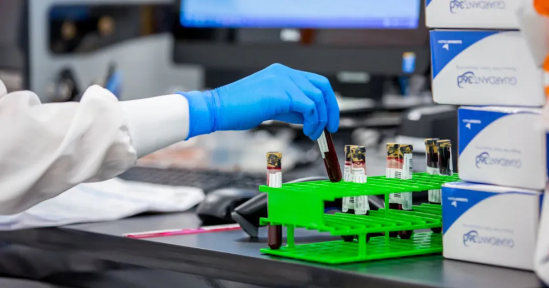 A pathologist handling blood samples in a Guardant Health lab