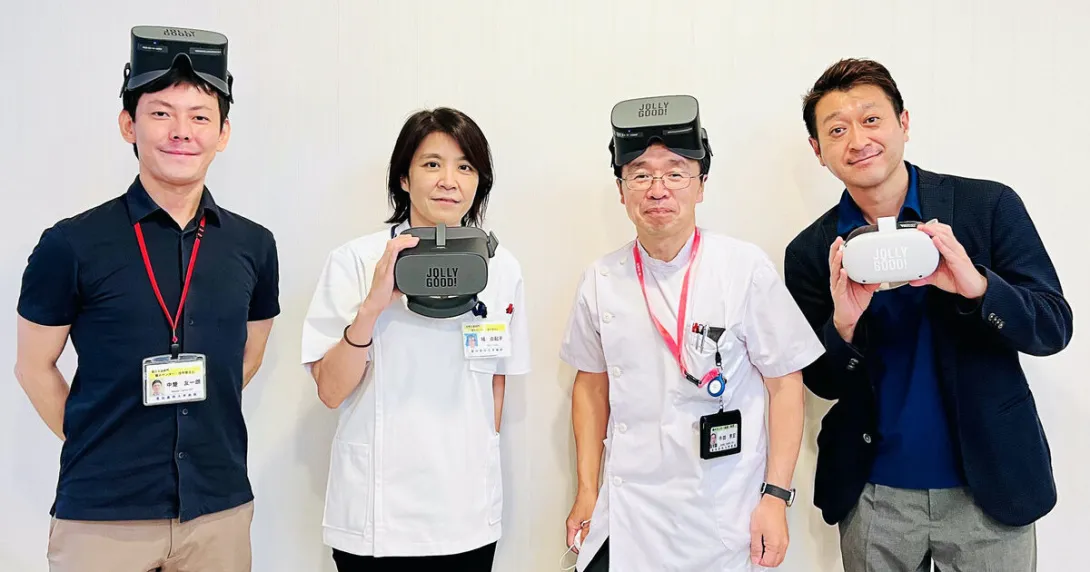 Representatives from Jolly Good and Aichi Medical University Hospital's Pain Center wear the Jolly Good VR headset