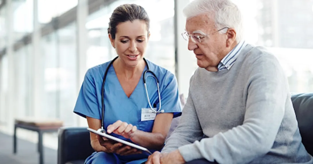 Older patient speaking with healthcare professional