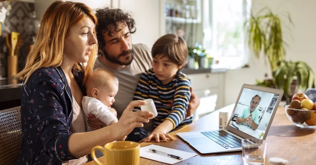 Family communicating with healthcare professional via telehealth