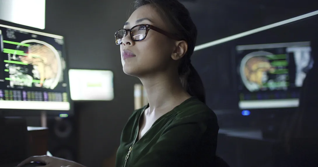 Person at a desk looking at a computer