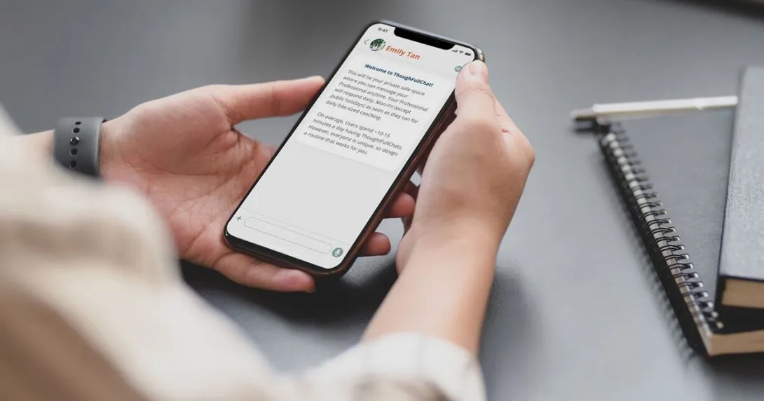 A person using the ThoughtFullChat mobile app