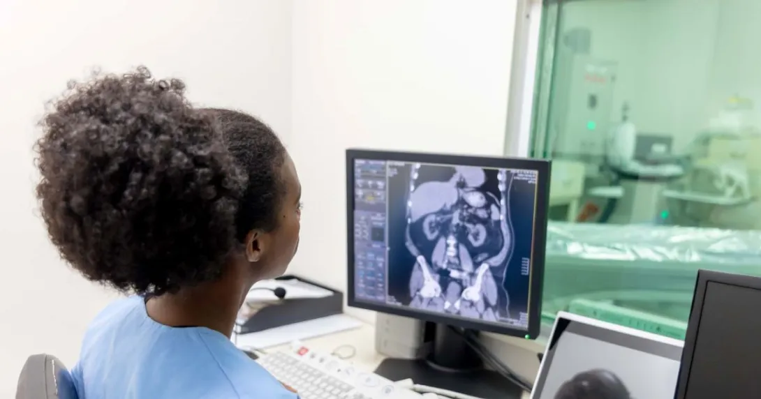 Radiologist looking at CAT scan monitor