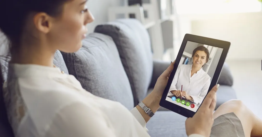 Person interacting with a healthcare professional via tablet