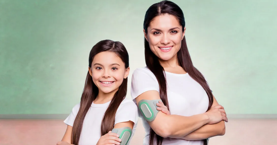 An adult and child wearing the Nerivio device.