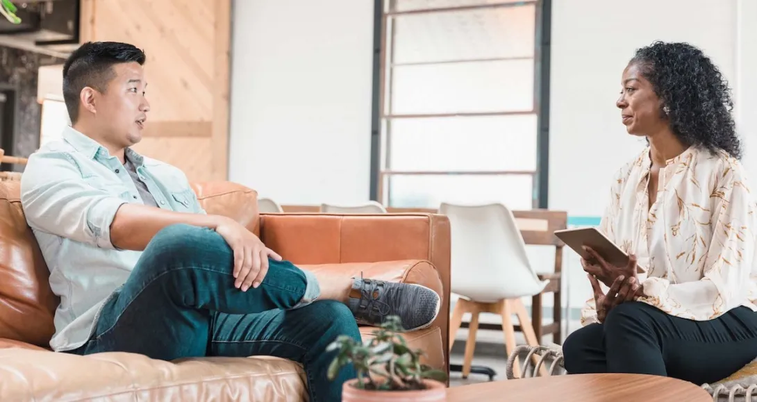 Patient in therapy session with therapist using a tablet