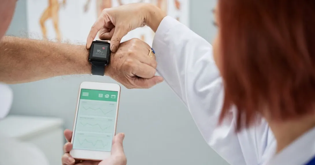 A doctor helping a patient set up a wearable watch