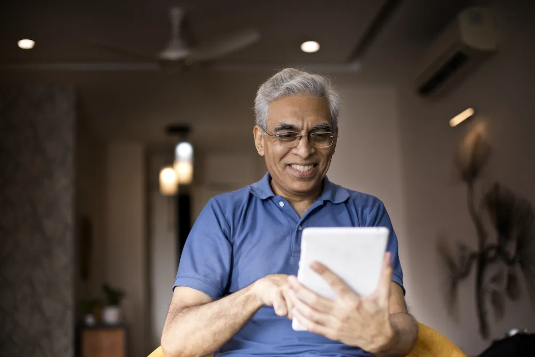 An older man using a tablet