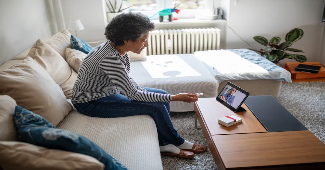 Senior woman on a video telemedicine call with a doctor at home