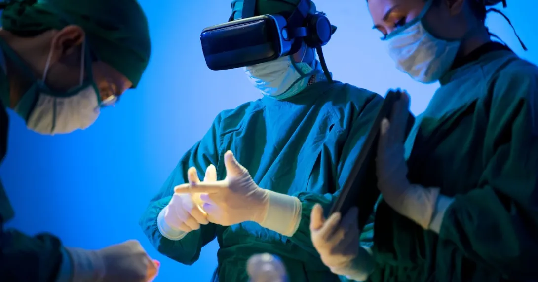 Three healthcare providers in the surgery setting with one wearing a virtual reality headset