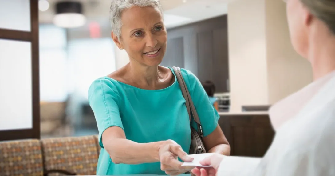 Person giving a healthcare provider a piece of paper